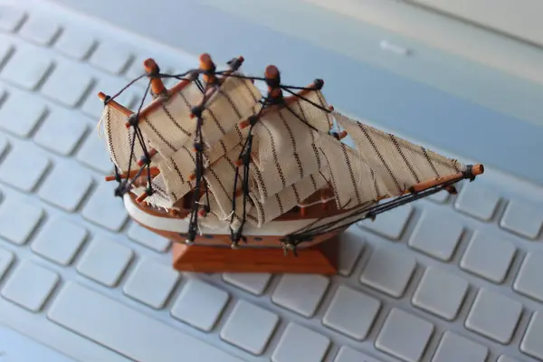 stock image Wooden Ship Model Stay On Keyboard With Empty Buttons