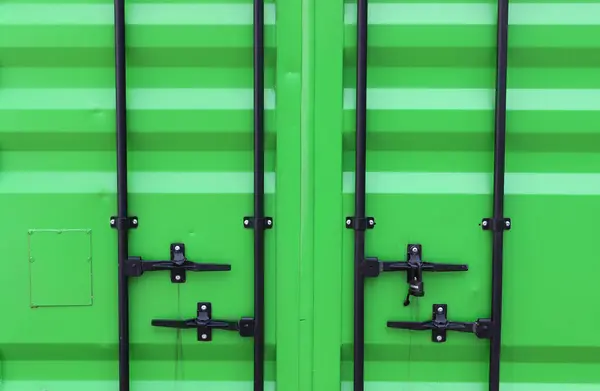 stock image  Locking Handles And Bolted Locking Beams On A Green Metal Cargo Container Door. Freight Container Door Texture. Metal Cargo Box Pattern 