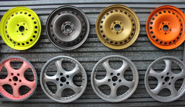 stock image Multicolored samples of possible wheel rim paint for different cars