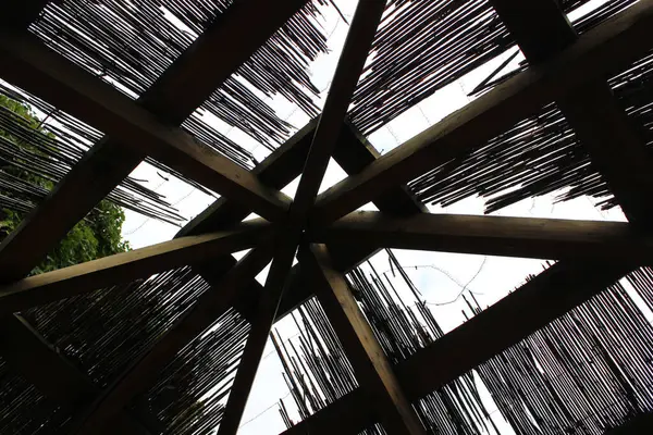 stock image The process of covering a reed roof over an open wooden gazebo