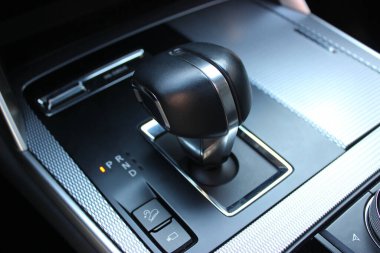 Car Center Console with dials, buttons and gear knob. Variety upholstery for controls and gear lever in modern vehicle clipart