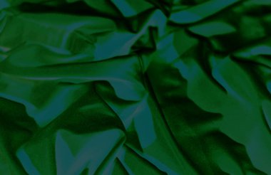 Üzerinde ışık efektleri olan buruşuk yeşil bir yüzey.