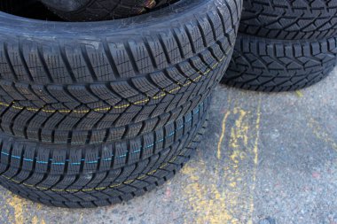 Variety Studless Car Tires For Mud And Snow In A Stack On The Road. Seasonal Tires Change Image  clipart