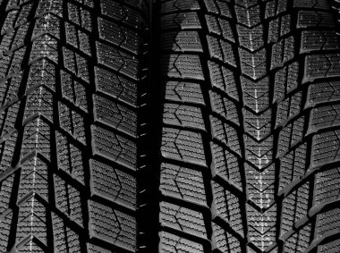 Directional design of the tread of car tires turned in different side of rotation. Textured pattern of directional tread blocks on a car tire clipart