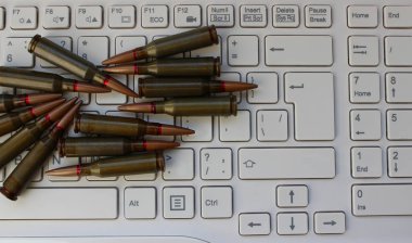 Beyaz bir dizüstü bilgisayarda kurşun yığınının kavramsal fotoğrafı. Suç Laboratuvarı ve Balistik Araştırma Stoku Resmi