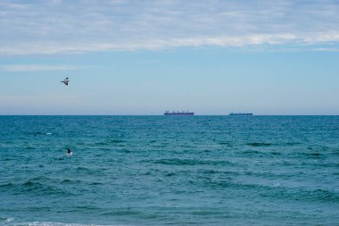 Büyük beyaz bir gemi denize karşı duruyor.