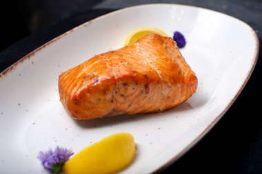 Beyaz tabakta krema soslu somon.