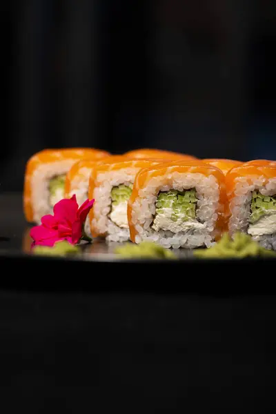 sushi on black background. close up. sushi with salmon, tuna, cucumber, caviar. sushi roll with cream and salmon. sushi roll with