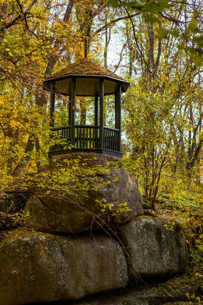 a beautiful view of a wooden gazebo in a park