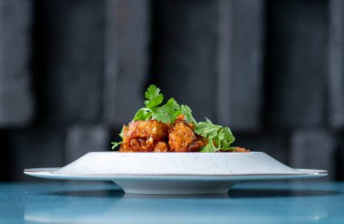 kızarmış tavuk kanatları beyaz plaka üzerinde.