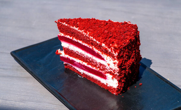 red velvet cake on a wooden board with a fork. close up.