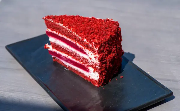 red velvet cake on a wooden board with a piece of cake