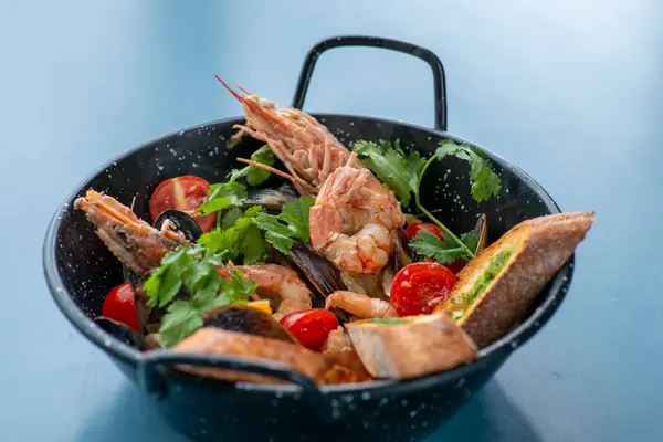 grilled shrimp, mussels and shrimps with herbs, lemon and tomatoes.