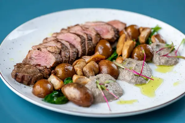 beef steak with potatoes, mushrooms, mushrooms and herbs