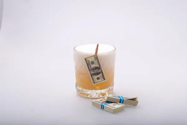 dollar and money. a glass of money with a candle.