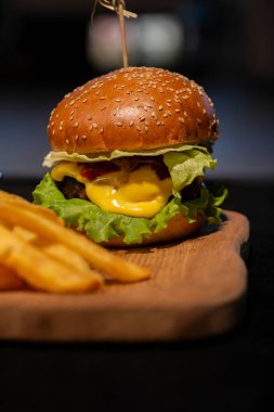 Siyah arka planda lezzetli bir burger.