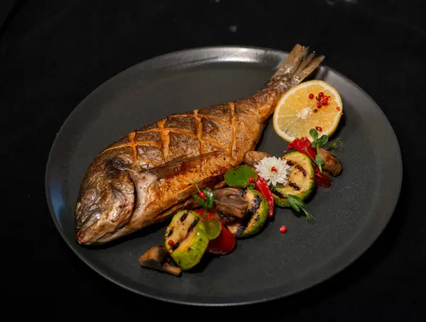 grilled fish with vegetables and herbs