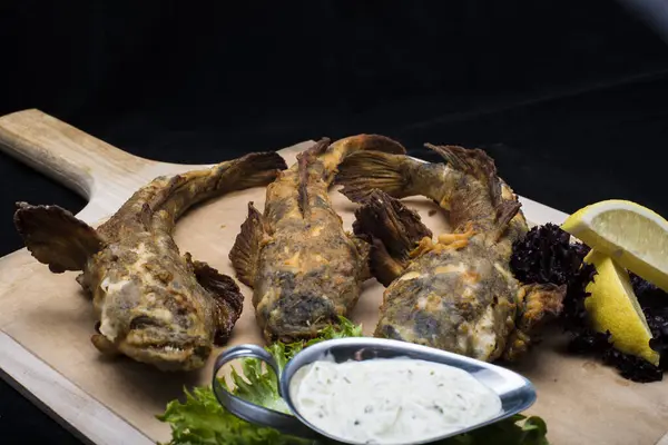 Stock image fried fish and chips on black board