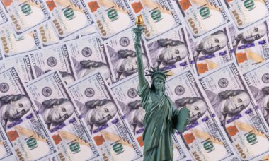 Statue of Liberty on the background of bills in denominations of 100 US dollars