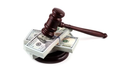 Judge's gavel and 100 american dollar banknotes on white background