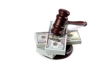 Judge's gavel and 100 american dollar banknotes on white background