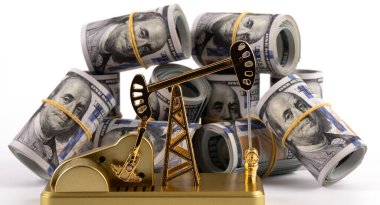 Gold oil pump model and rolled up 100 american dollar bills