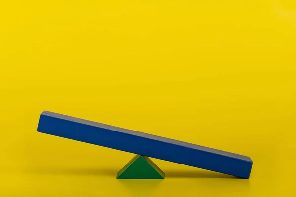 Empty wooden balance board on yellow background