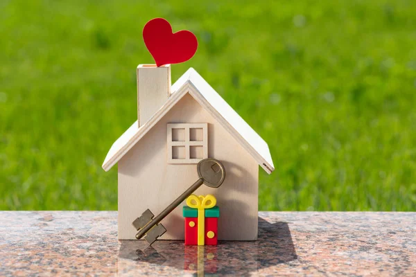 stock image Symbolic wooden house with a human heart symbol in a chimney on the roof