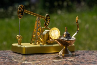 Alaaddin 'in sihirli lambası, Suudi Arabistan Krallığı' nın 1 riyal parası ve bir altın yağ pompası modeli.