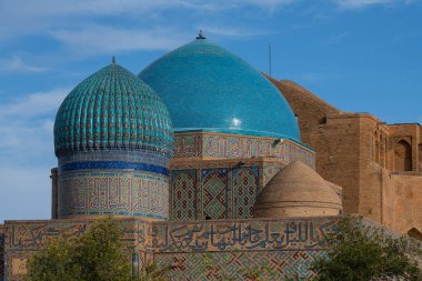 The domes of the medieval mausoleum of Khoja Akhmet Yassawi in the Kazakh city of Turkestan - the heart of the Turkic world clipart