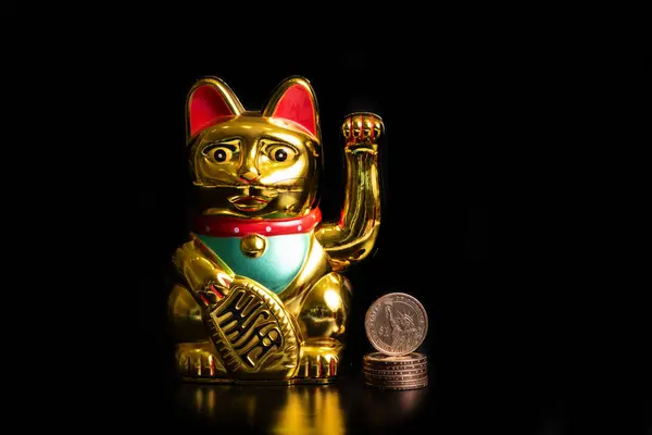 Classic Chinese cat figurine bringing financial prosperity and 1 US dollar coin