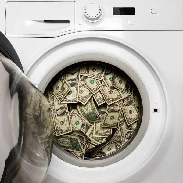 Conceptual story about corruption and money laundering with a washing machine filled with dirty 1 US dollar bills