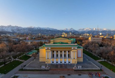 Almaty, Kazakistan, 02.04.2024. Kazak şehri Almaty 'nin merkez kısmının dörtte birinden sabah ilkbahar manzarası ve 1941 yılında inşa edilen Ulusal Opera ve Bale Tiyatrosu.