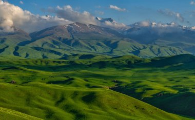 Trans-Ili Alatau 'daki (Kazakistan) karla kaplı tepe zeminine karşı pitoresk bir plato)
