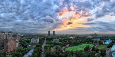 Almaty, Kazakistan, 05.19.2024. Bir bahar akşamı gün batımında Kazak şehrinin merkezi manzarası.