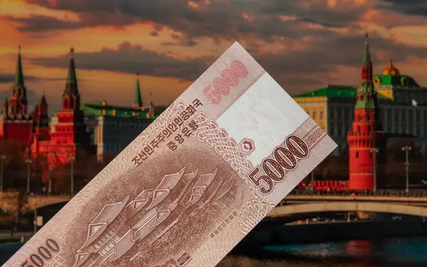 stock image 5000 won banknote of the Korean People's Democratic Republic against the backdrop of the Moscow Kremlin buildings