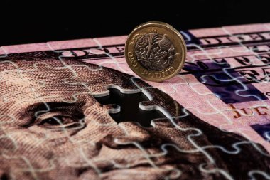 Bulmacalardan 100 dolar ve 1 İngiliz sikkesi.