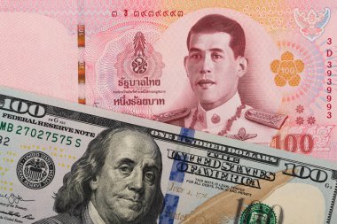 100 Tayland bahtı ve 100 Amerikan doları banknotları.