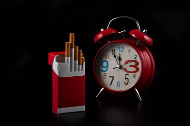 Open red pack of cigarettes on black background clipart