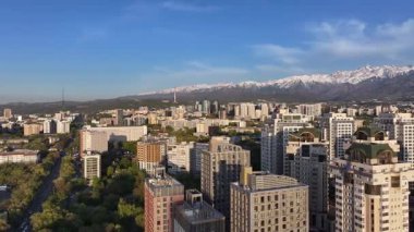 Almaty, Kazakistan, 04.20.2025. Bir bahar akşamı Kazak şehri Almaty 'nin merkezindeki yüksek katlı binalara ait bir kuadkopter görüntüsü.