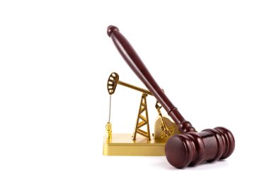 Golden miniature oil pump and hammer judge on white background