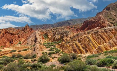 A picturesque gorge with multi-colored clay on the southern shore of the Kyrgyz lake Issyk Kul