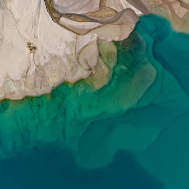 A quadcopter view of Lake Issyk (Almaty Region, Kazakhstan) and the mountain river flowing into it on an autumn morning.