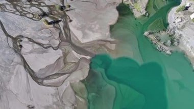 A quadcopter view of Lake Issyk (Almaty Region, Kazakhstan) and the mountain river flowing into it on an autumn morning.