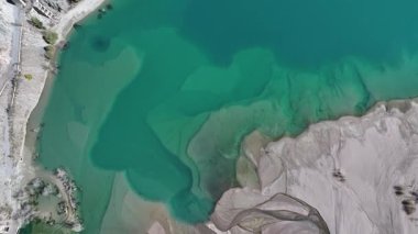 A quadcopter view of Lake Issyk (Almaty Region, Kazakhstan) and the mountain river flowing into it on an autumn morning.