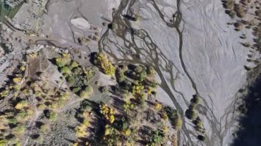A quadcopter view of Lake Issyk (Almaty Region, Kazakhstan) and the mountain river flowing into it on an autumn morning.
