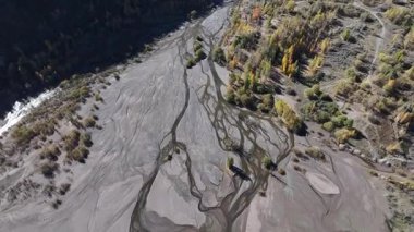 A quadcopter view of Lake Issyk (Almaty Region, Kazakhstan) and the mountain river flowing into it on an autumn morning.