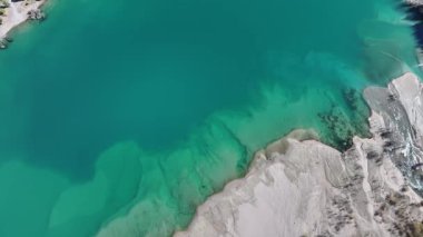 A quadcopter view of Lake Issyk (Almaty Region, Kazakhstan) and the mountain river flowing into it on an autumn morning.