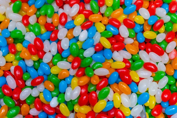 stock image Colorful sweet hard candy, mutitude of bombons in a bowl, texture of sugar covered candy in a lot of vibrant colors. Pills like looking candy.