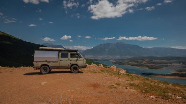 Macera kamyonu ya da karavan, yüksek ovalarda karavan, güzel manzaralı bir yaz günü Kukes şehri manzarası. Eski bir karavanla Arnavutluk gezisi